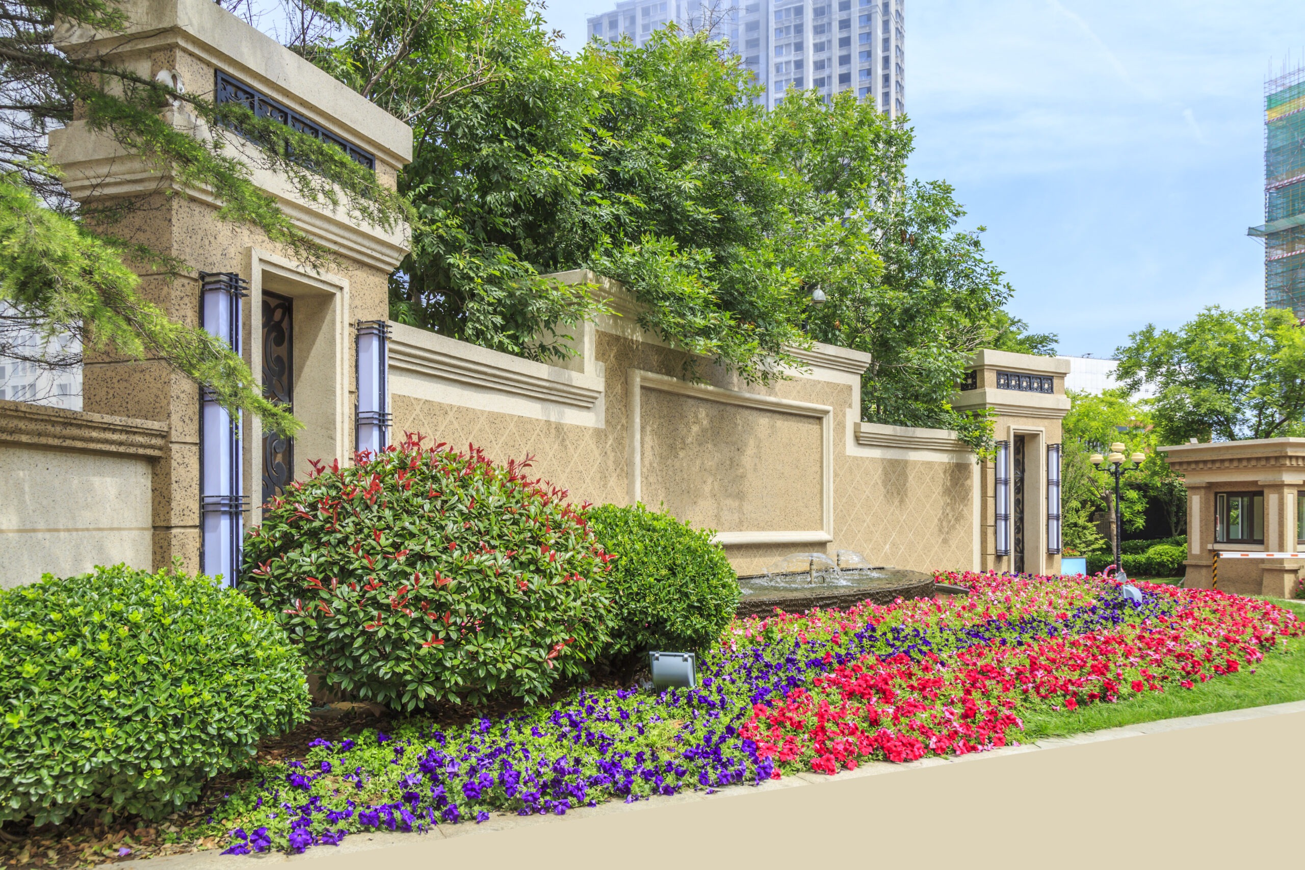 Commercial property landscaping design with city skyline by All Pro Landscaping providing lawn care in Smyrna, GA for well-maintained business environments.